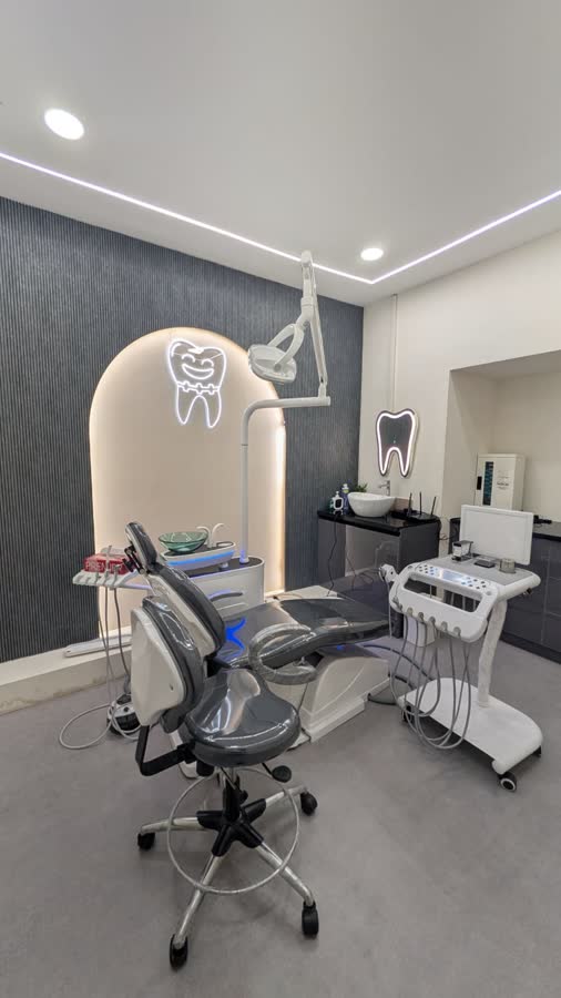 The main treatment room: the chair, under a lit arch with the practice's tooth in it